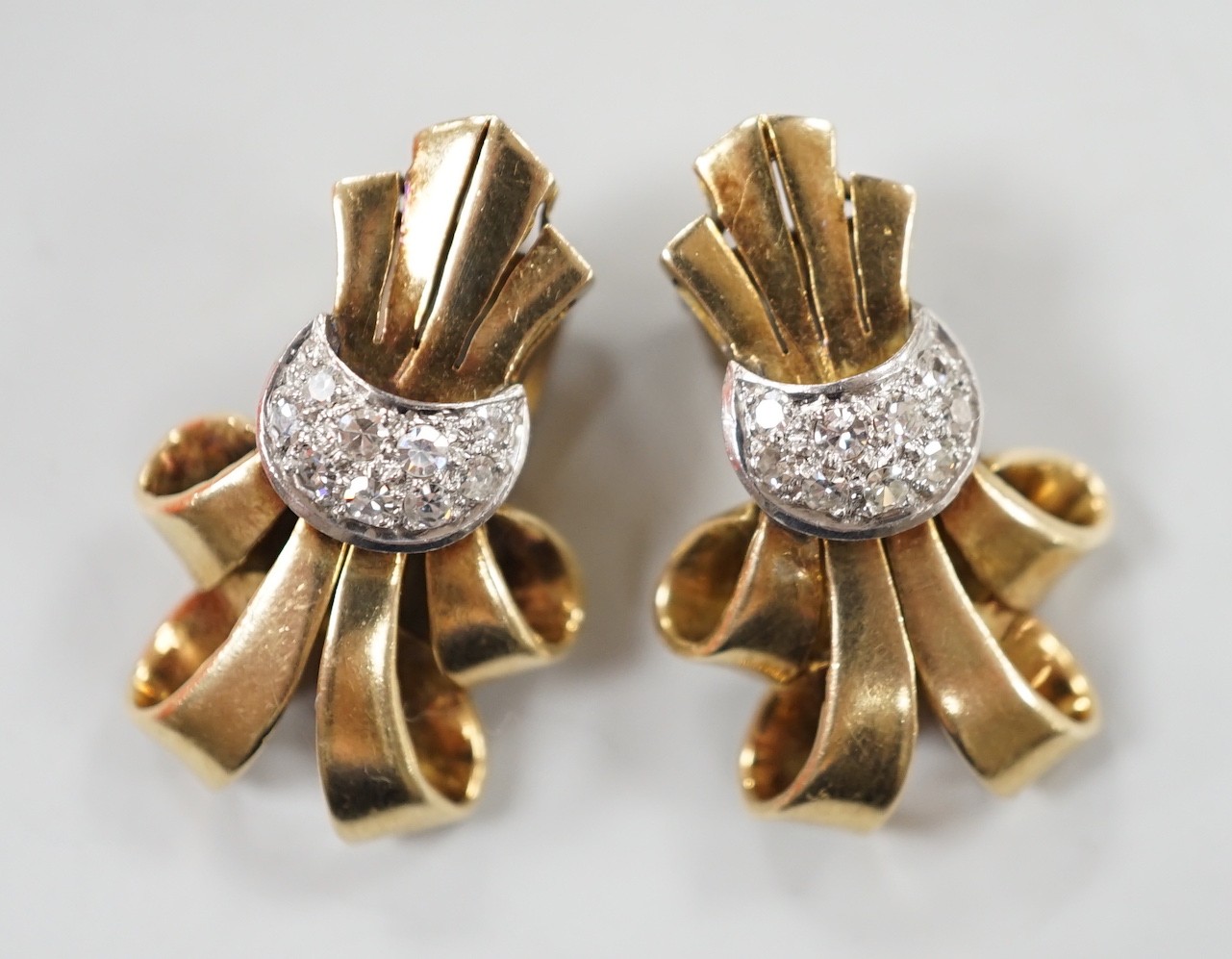 A pair of mid 20th century yellow and white metal, diamond cluster set scroll ear clips, 27mm, gross weight 13.5 grams.